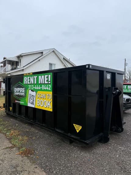 Empire Dumpsters roll-off truck delivering a dumpster in Dearborn