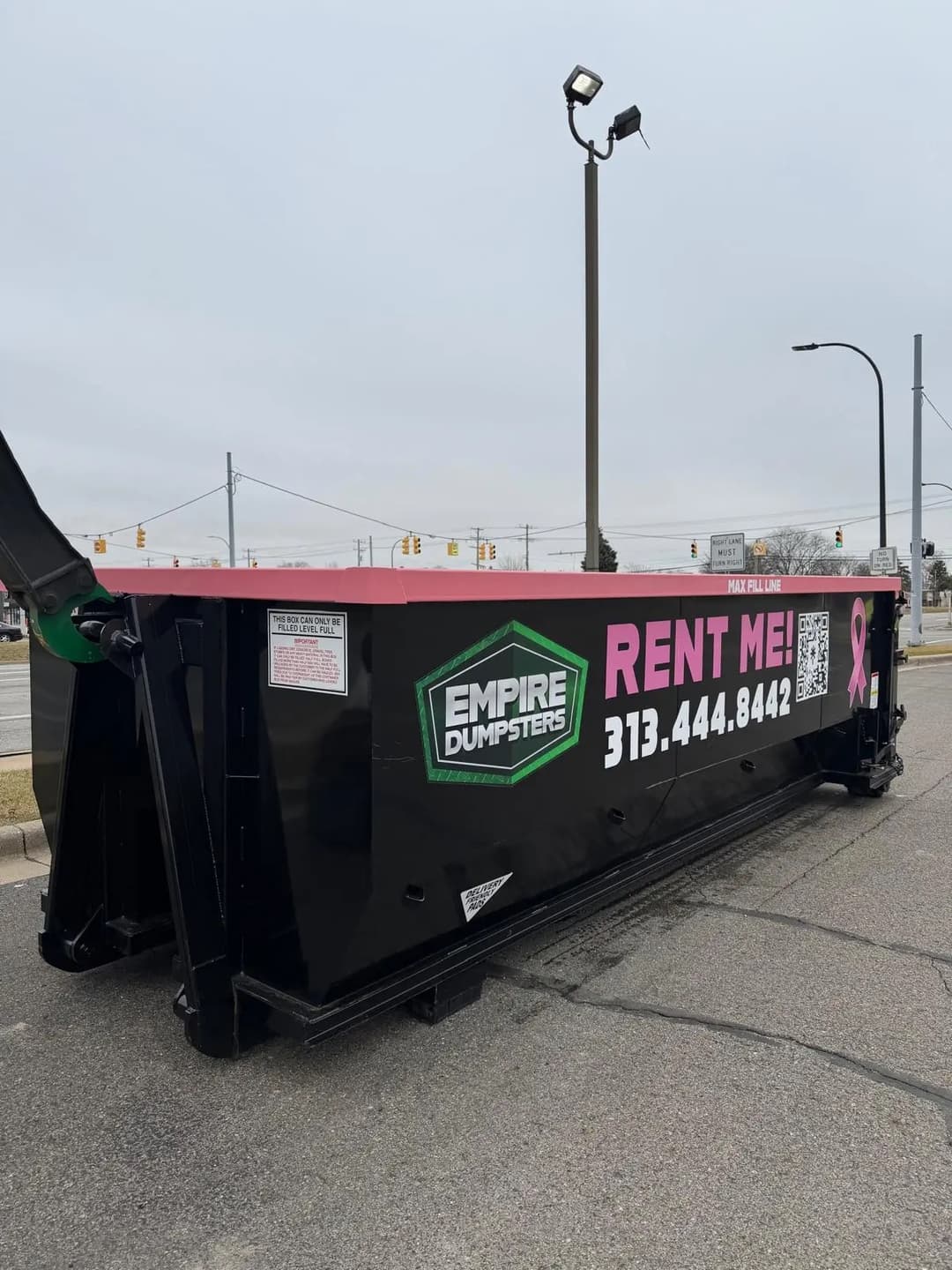 Empire Dumpsters truck and roll-off dumpster on a residential street
